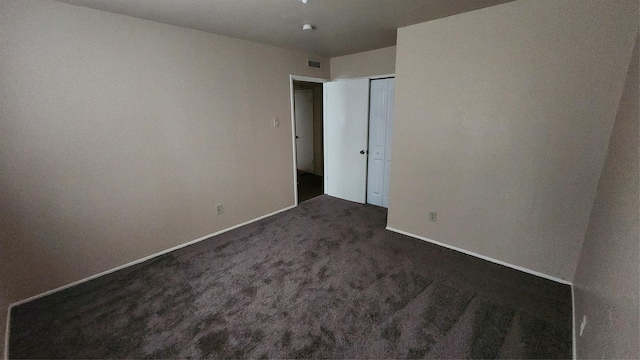 437 W Grenoble Dr, Grand Prairie, TX 75052 - interior space featuring visible vents, dark carpet, and baseboards