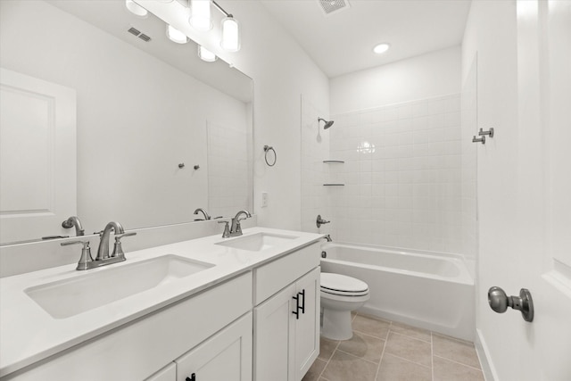 bathroom featuring toilet, tile patterned flooring, a sink, and visible vents