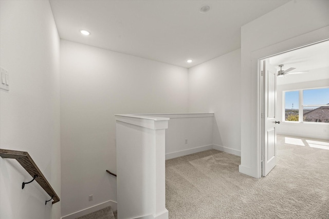 hallway with carpet, baseboards, an upstairs landing, and recessed lighting