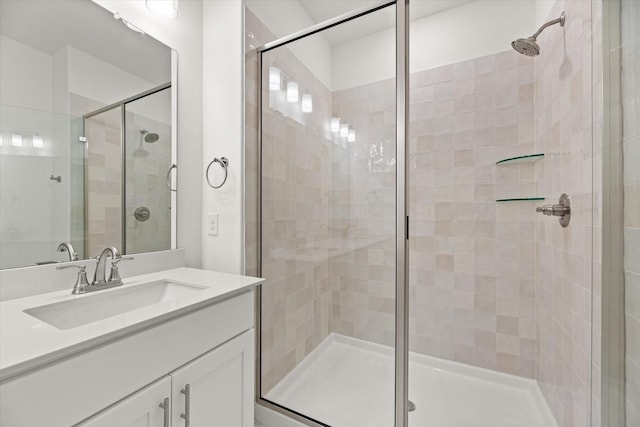 bathroom with a stall shower and vanity