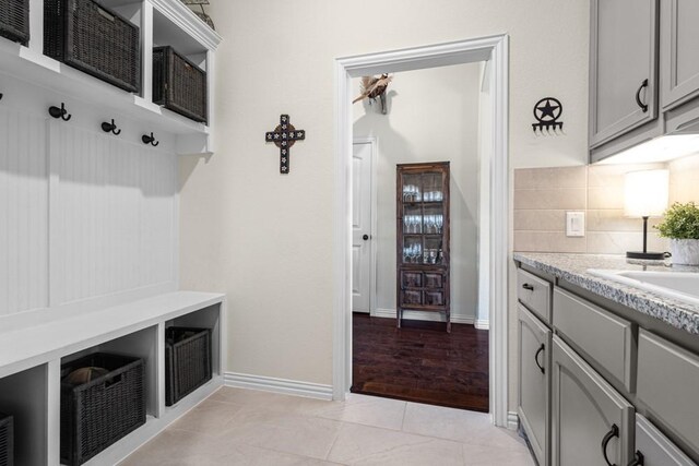 mudroom with baseboards and light tile patterned floors