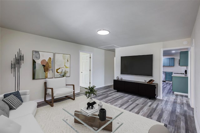 living room with baseboards and light wood-type flooring