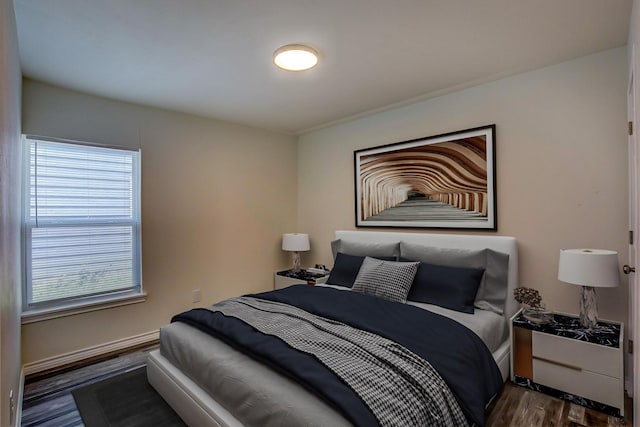 bedroom featuring baseboards and dark wood-style floors