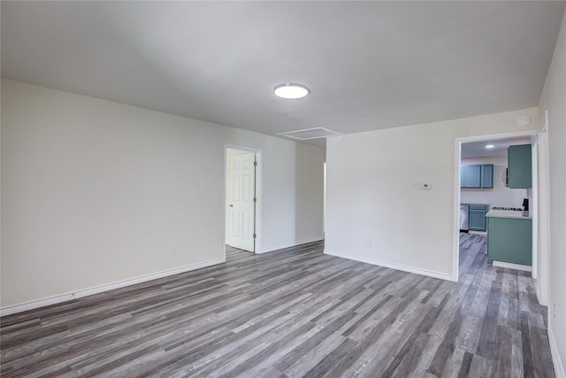 empty room featuring wood finished floors and baseboards