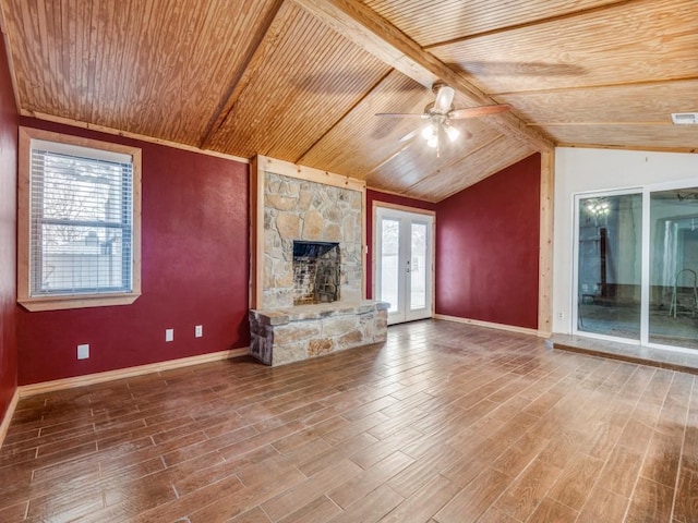 unfurnished living room with lofted ceiling with beams, wooden ceiling, ceiling fan, wood finished floors, and a fireplace