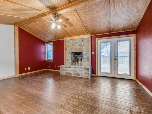 unfurnished living room featuring vaulted ceiling with beams, wood ceiling, wood finished floors, and french doors