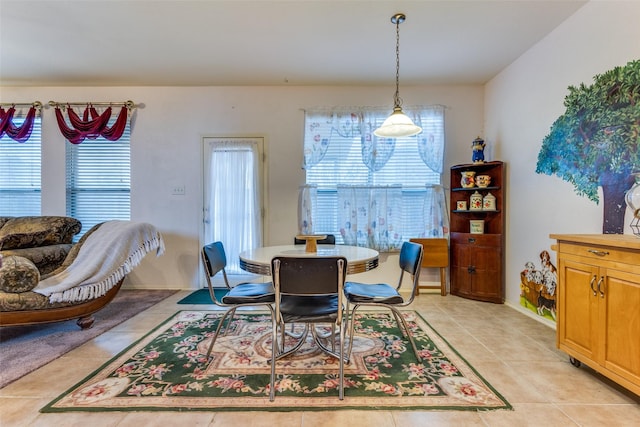 dining room with baseboards and light tile patterned floors