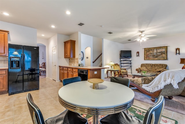 dining area featuring arched walkways, visible vents, recessed lighting, and light tile patterned flooring