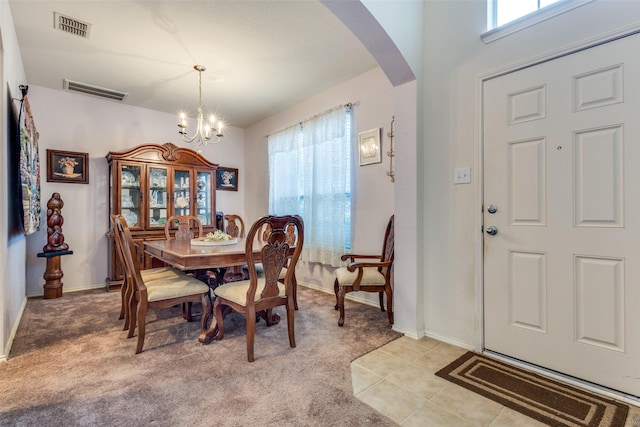 dining space with arched walkways, visible vents, and a healthy amount of sunlight