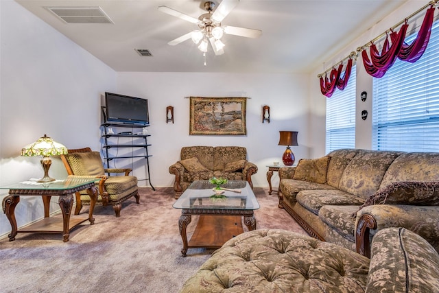 carpeted living room featuring visible vents and a ceiling fan