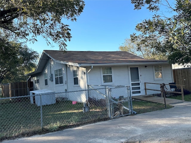 view of front facade featuring fence private yard and a gate