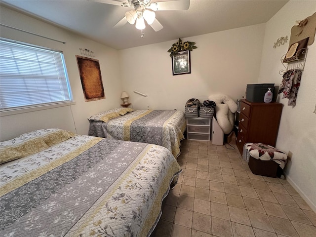 bedroom featuring ceiling fan and tile patterned flooring