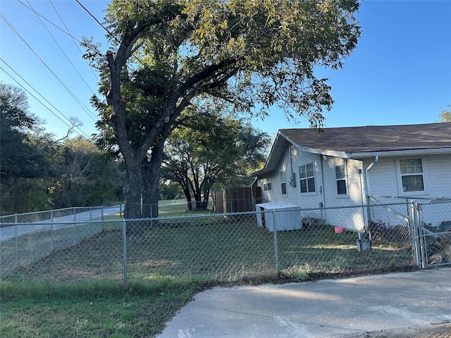 view of property exterior featuring fence private yard and a lawn