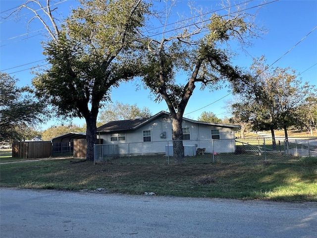 view of side of home featuring a fenced front yard and a yard