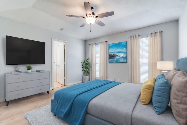 bedroom with light wood finished floors, ceiling fan, and baseboards