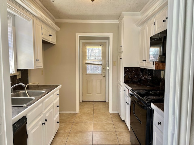 kitchen with light tile patterned flooring, a sink, white cabinets, black appliances, and tasteful backsplash