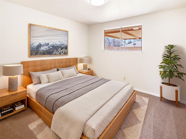 carpeted bedroom featuring baseboards