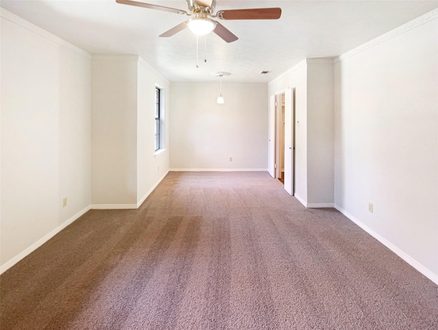 spare room with carpet, baseboards, a ceiling fan, and ornamental molding