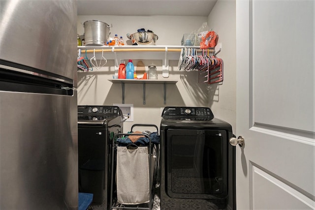 washroom featuring laundry area and washing machine and clothes dryer