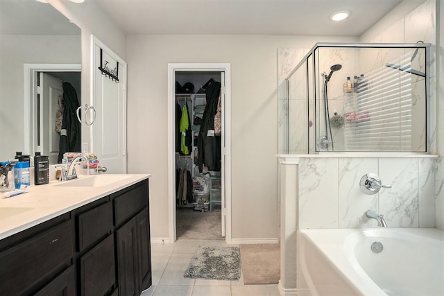 bathroom featuring a washtub, double vanity, a spacious closet, an enclosed shower, and a sink