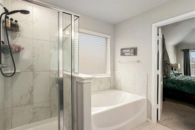 bathroom featuring a garden tub, ensuite bath, and a shower stall