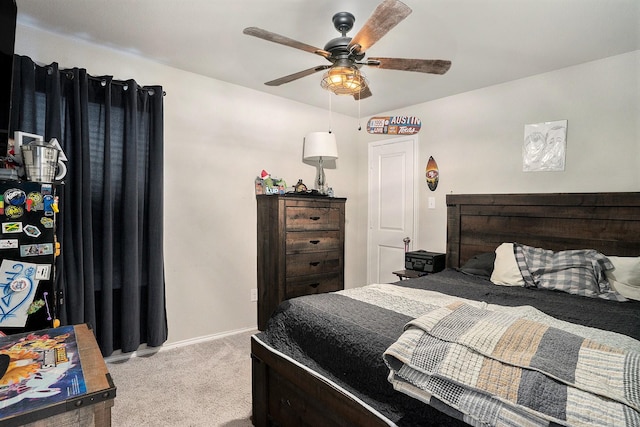 carpeted bedroom with ceiling fan and baseboards