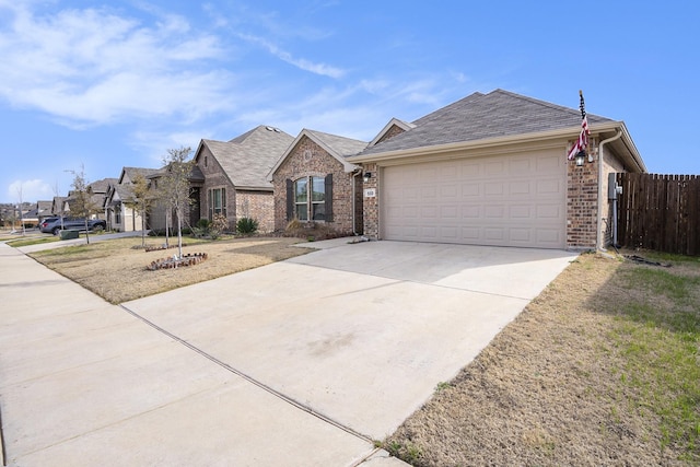 view of front of property with a garage, fence, concrete driveway, and brick siding