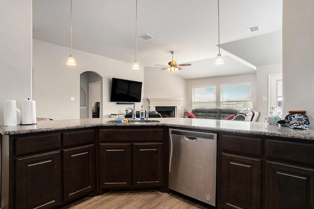 kitchen with visible vents, a sink, stainless steel dishwasher, and dark brown cabinets