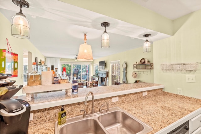 kitchen with open floor plan, a sink, and hanging light fixtures