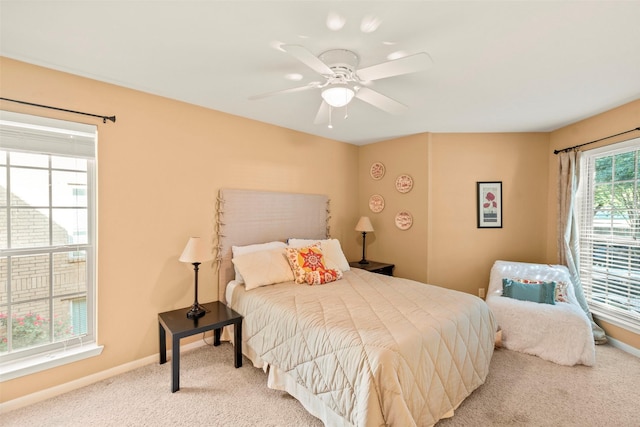 carpeted bedroom featuring baseboards and ceiling fan