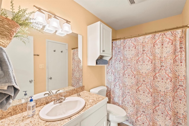 bathroom featuring toilet and vanity