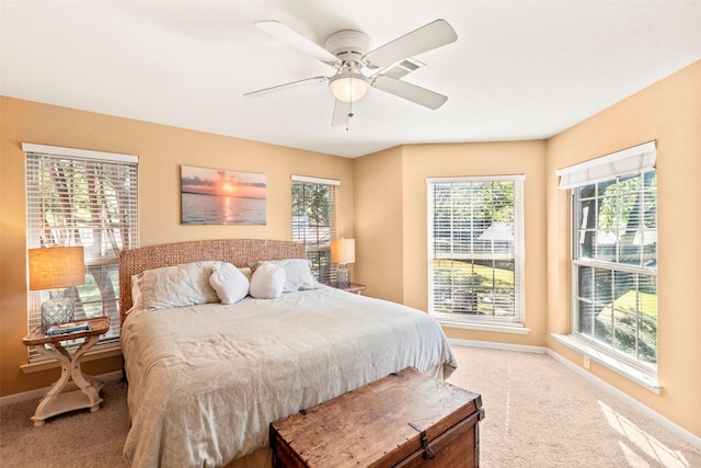 bedroom featuring baseboards, carpet flooring, and multiple windows