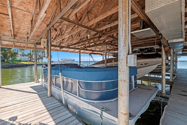 dock area with boat lift and a water view