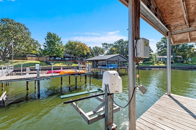 view of dock with boat lift and a water view