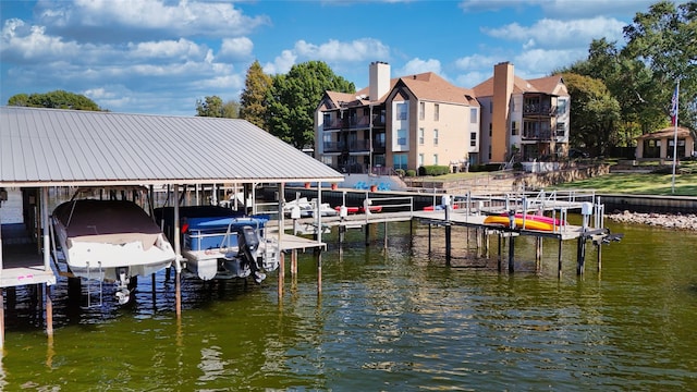 dock area featuring boat lift and a water view