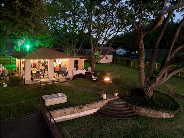 view of yard featuring a fire pit, a patio, and fence