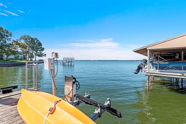 dock area with a water view and boat lift