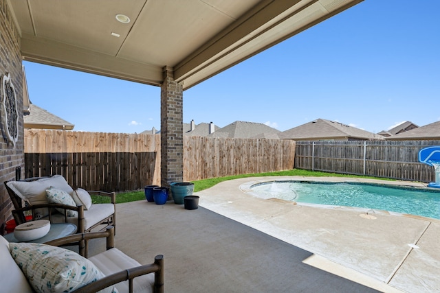 view of pool with a fenced in pool, a fenced backyard, and a patio