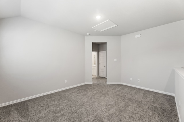 unfurnished room featuring attic access, carpet flooring, and baseboards