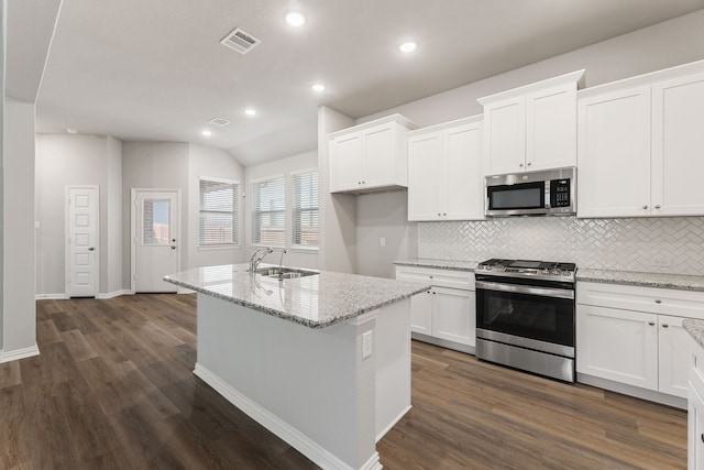 kitchen featuring white cabinets, visible vents, stainless steel appliances, and a sink