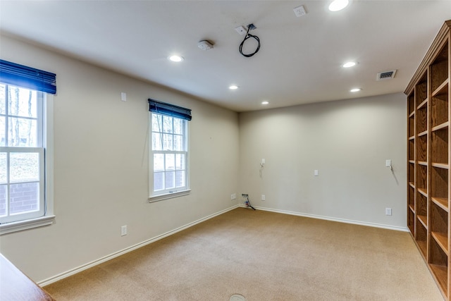 spare room featuring carpet flooring, recessed lighting, visible vents, and baseboards