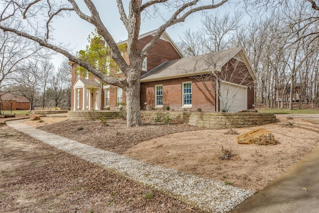 view of home's exterior with brick siding and an attached garage