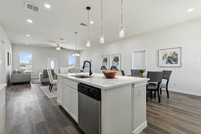 kitchen featuring pendant lighting, visible vents, stainless steel dishwasher, open floor plan, and a sink