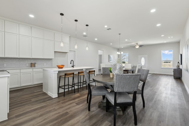 dining space featuring dark wood-style floors, baseboards, visible vents, and recessed lighting