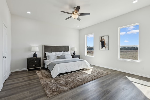 bedroom with baseboards, dark wood finished floors, a ceiling fan, and recessed lighting