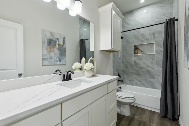 full bath featuring shower / bath combination with curtain, vanity, wood finished floors, and toilet