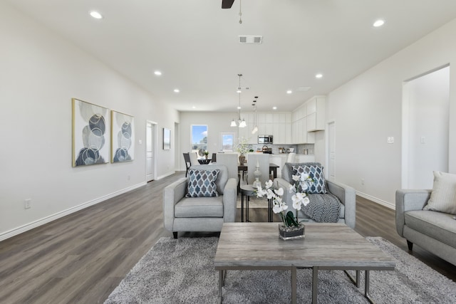 living room with visible vents, baseboards, ceiling fan, recessed lighting, and dark wood finished floors