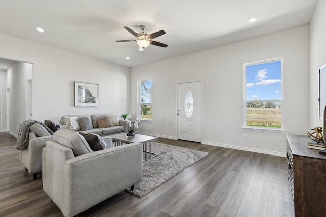 living area with a ceiling fan, baseboards, dark wood-type flooring, and recessed lighting