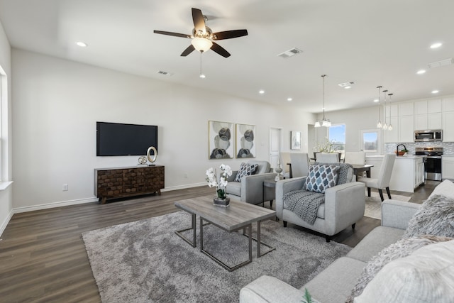 living room featuring recessed lighting, a ceiling fan, dark wood-style floors, and visible vents