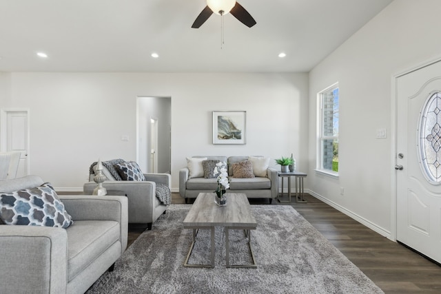 living room featuring baseboards, dark wood-type flooring, a ceiling fan, and recessed lighting